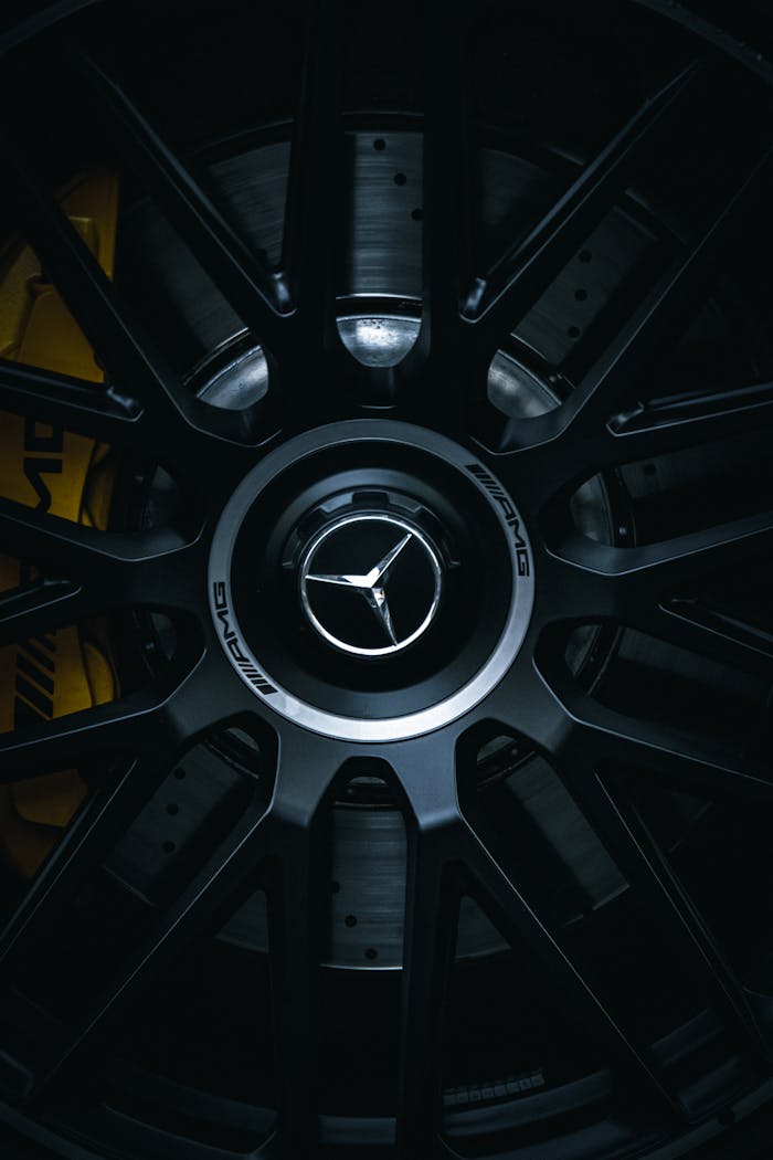 Detailed view of a high-performance luxury car wheel with AMG emblem.